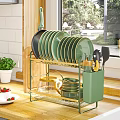 Golden Kitchenware Organizer with Green Black Plates Cups Spatulas and Transparent Kettle