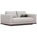 Green Velvet Two Seater Sofa With Round Pillows And Dark Wooden Base