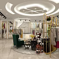 Modern Clothing Store Interior With Golden Racks Circular Display And Fashion Garments