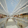 Modern Shopping Mall Interior With Glass Skylight Multi Level Walkways And Bright Storefronts
