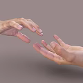 Woman's gentle hands reaching out softly towards each other on gray background