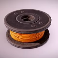 Black Spool With Yellow Wound Wire And Circular Design Holes On Surface 3d model