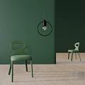 Green Velvet Single Chair In Room With Green Wall Wooden Floor And Pendant Light