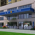 Modern Commercial Street Building Exterior With Glass Windows Blue Awning Surrounding Trees And Street Cars
