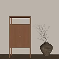 Wooden Decorative Cabinet With Metal Handles And Black Vase Branches Against Beige Wall