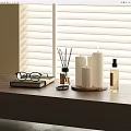 Elegant Decorative Accessories Set With Candles Aromatherapy Bottle Eyeglasses On Wooden Table By Window Blinds