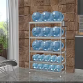 Stainless Steel Multi Tier Storage Rack With Blue Water Jugs In Kitchen Against Brick Wall
