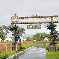 Scenic Wall with Wooden Arch Purple Flowers and Bamboo Fence Near Tents Rice Fields