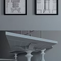Wooden Coffee Table With Carved Legs And Side Tables Against Gray Wall With Architectural Sketches