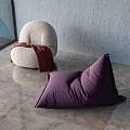 Light Gray Round and Purple Triangular Bean Bag Chairs with Red Blanket on Gray Floor and Light Blue Wall