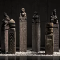Ancient Carved Stone Columns With Intricate Details And Statues In Gallery