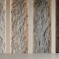 Textured Feature Wall with Stone Like Texture in Various Gray Tones Illuminated by Side Lighting for Modern Decor