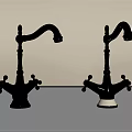 Two Gold and Silver Faucets on Gray Countertop with Light Colored Wall
