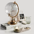 Organized Desktop Setup With Stacked Magazines Smartwatch Globe Laptop Photo Frame And Decorative Candles
