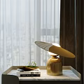 Elegant Table Lamp with Golden Base Wing Like Lampshade on White Table by Window
