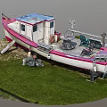 Vintage Red and White Boat Moored at Wooden Dock with Green Grass and Chairs