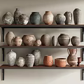 Various Ceramic Vessels Displayed On Wooden Shelves With Different Shapes And Earthy Tones