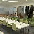 Modern Public Interior Space With Long Table Green Chairs Sofas TV And Decorative Partition