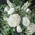 Beautiful Elegant White Roses and Hydrangeas Arrangement in Dark Vase with Green Eucalyptus Leaves