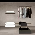 Modern Stylish Clothes Hanging On Hangers With White Pillows And Folded Blankets