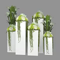 Green and White Flowers Arrangement with Hanging Green Vines in White Cube Vases