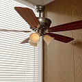 Ceiling Fan With Wooden Blades And Integrated Chandelier Lights In Modern Room Setting