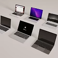 Various Modern Laptops With Apple Logo Different Screen Displays And Colors