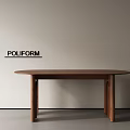 Round Wooden Dining Table with Modern Design by POLIFORM Against Light Colored Wall
