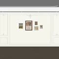 White Wall Interior With Decorative Molding And Framed Artworks And Herringbone Wooden Floor Design