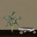 Transparent Vase Holding Green Leaves And White Flowers Against Light Gray Wall With White Book