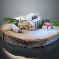 Traditional Christmas Stollen Cake on Wooden Base with Snow and Decorations