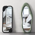 Two Decorative Mirrors with Black Green Frames Irregular Shapes on White Wall Reflecting Indoor Scene