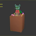 Black Cat With Green Eyes Purple Cape Sitting On Orange Cube With Pink Yellow Objects