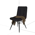 Black Leather Lounge Chair With Tufted Design And Gray Blanket On Metal Legs