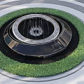 Elegant Circular Garden Ornament With Central Fountain And Green Foliage Ring Structure