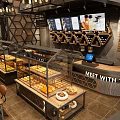 Modern Bubble Tea Shop Interior With Hexagonal Decor Display Shelves And Menu Boards