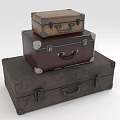 Stacked Leather Suitcases In Brown Dark Brown And Gray With Metal Fittings