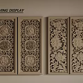Wooden Carving Display with Decorative Panels Featuring Floral Patterns and Circular Designs
