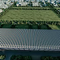 Modern Industrial Factory Building With Metal Roof And Surrounding Green Trees Area