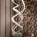 Intricate Silver Spiral Sculptural Art With Wooden Background And Triangular Cutouts