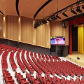 Banquet Hall Interior With Red Seats Stepped Rows Wooden Stage And Lighting Fixtures