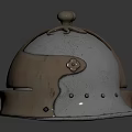 Two Antique Metal Helmets With Decorative Tops And Riveted Edges On Shiny Surface
