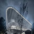 Modern Sales Office Building Exterior With Curved Glass Facade And Night Lighting