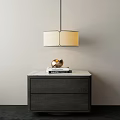 Modern Pendant Chandelier Hanging Above Dark Wood Cabinet With Marble Top And Decorative Sphere