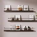Black Wall Mounted Three Tier Display Shelves Holding Magazines On Light Wall With Green Plant