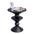 Black Spiral Base Side Table With White Statue And Open Magazine