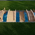 Wooden Landscape Bridge With Multiple Arches Over Water In Green Lawn