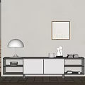 Modern Sleek TV Stand with Table Lamp Sculpture Books and Wall Art on Neutral Wall