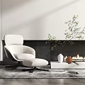 Modern White Single Sofa With Ottoman And Green Plant By Black Fireplace