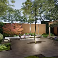 Tranquil Courtyard Garden with Person Standing Among Lush Trees Green Lawn Water Pond and Stone Benches